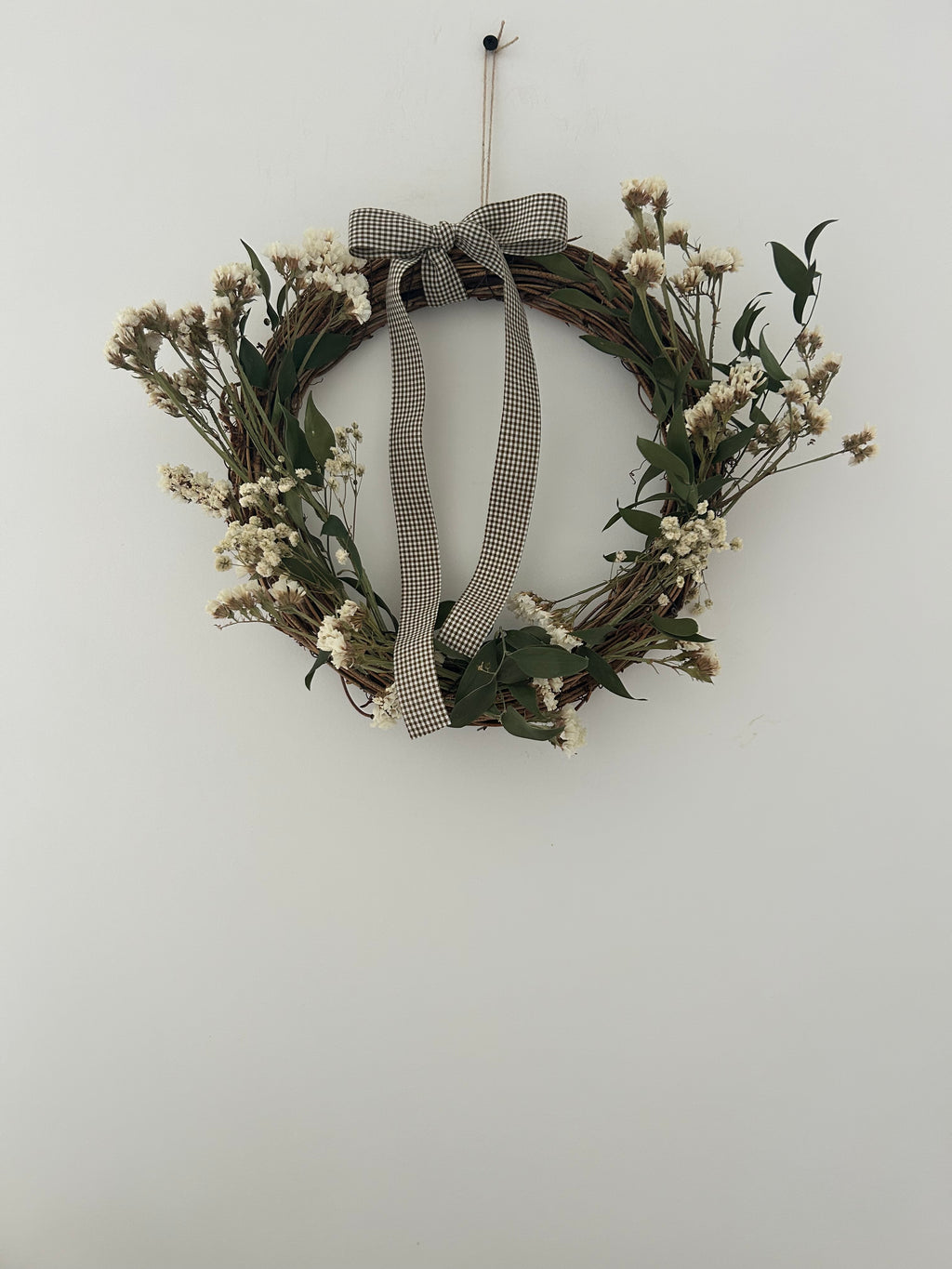 ‘Meadow’ Wreath with White Statice and Ruscus finished with a dark brown gingham bow