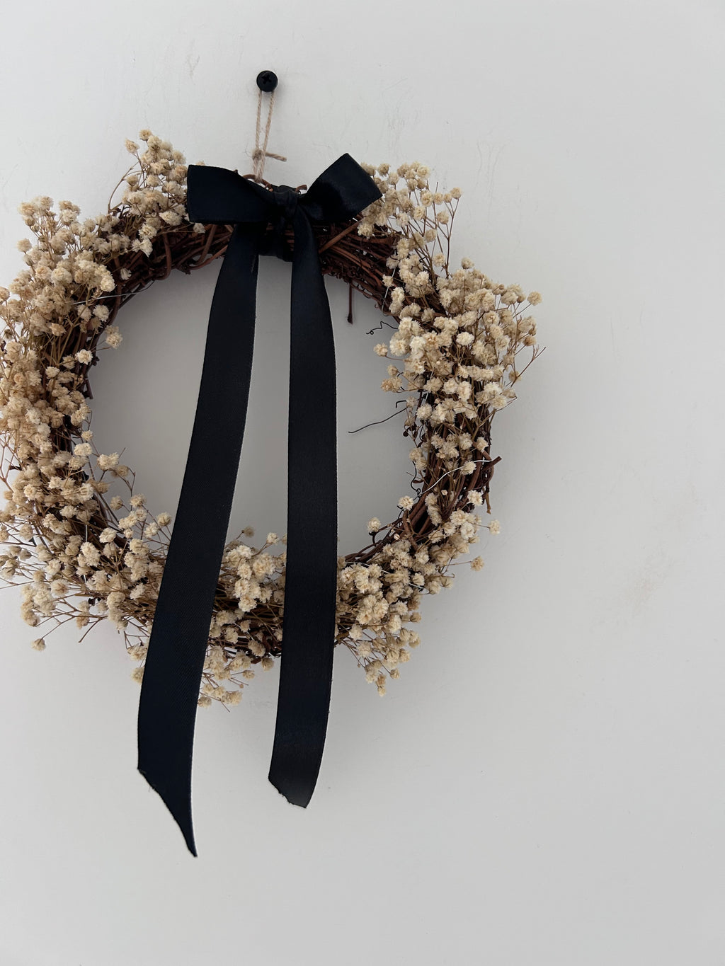‘Onyx’ Wreath with Gypsophilas finished with a black bow