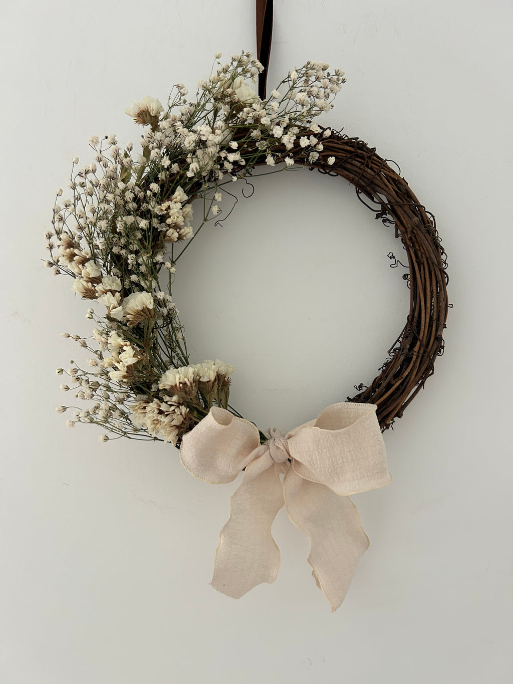 ‘Flora’ Wreath with Gypsophilas and White Statice finished with cream bow 20cm