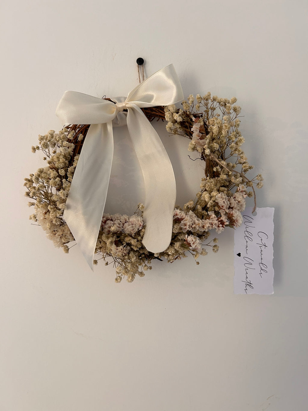 ‘Luchia’ Wreath with white statice, gypsophilas finished with a cream bow