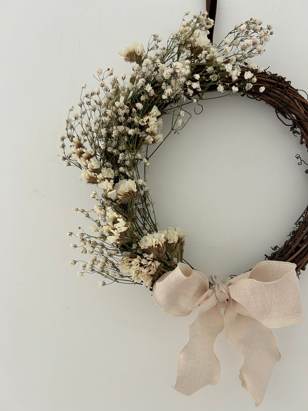 ‘Flora’ Wreath with Gypsophilas and White Statice finished with cream bow 20cm