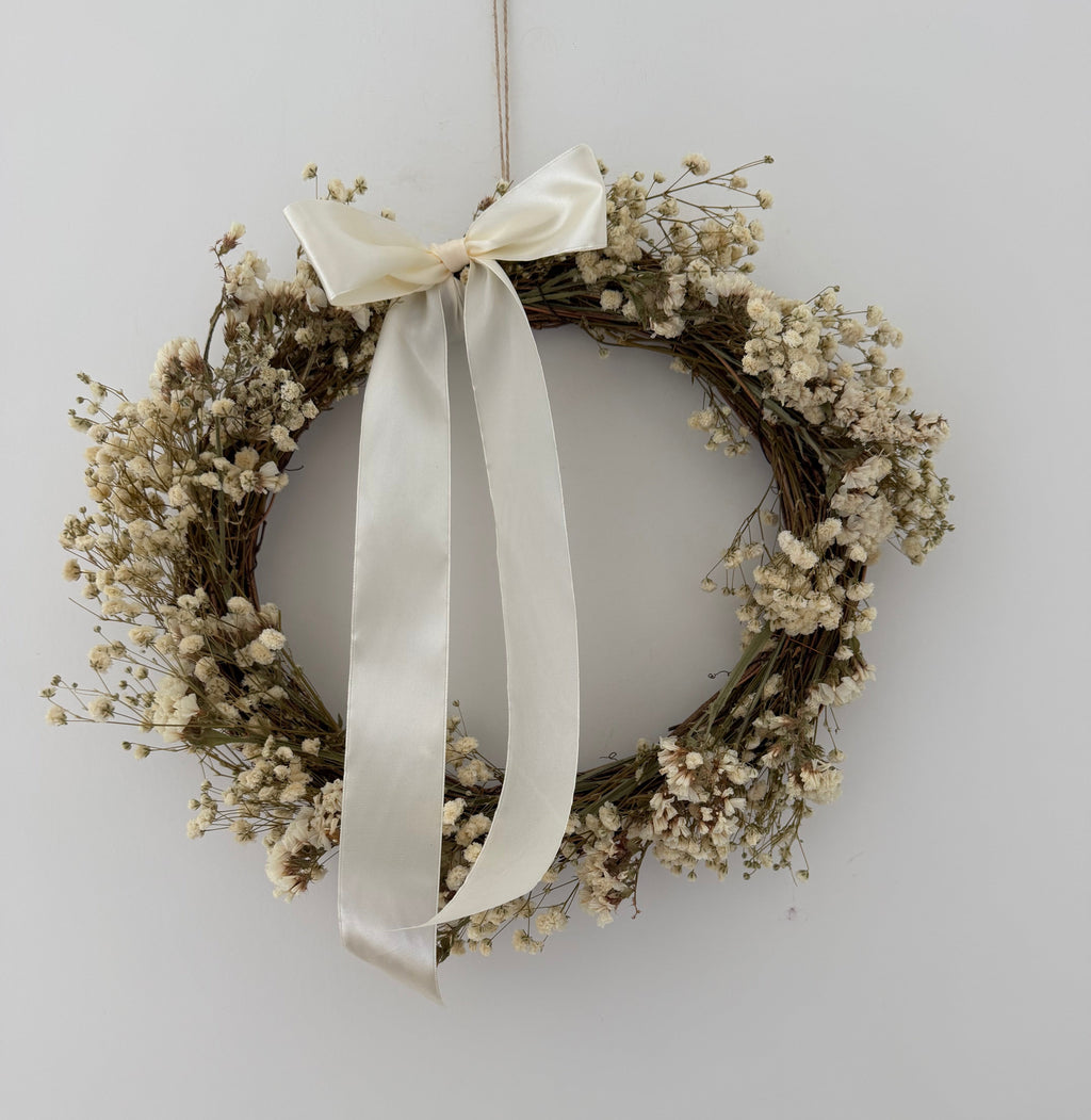 ‘Luchia’ Wreath with white statice, gypsophilas finished with a cream bow