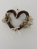 20cm heart wreath with gypsophilas finished with a ivory velvet bow