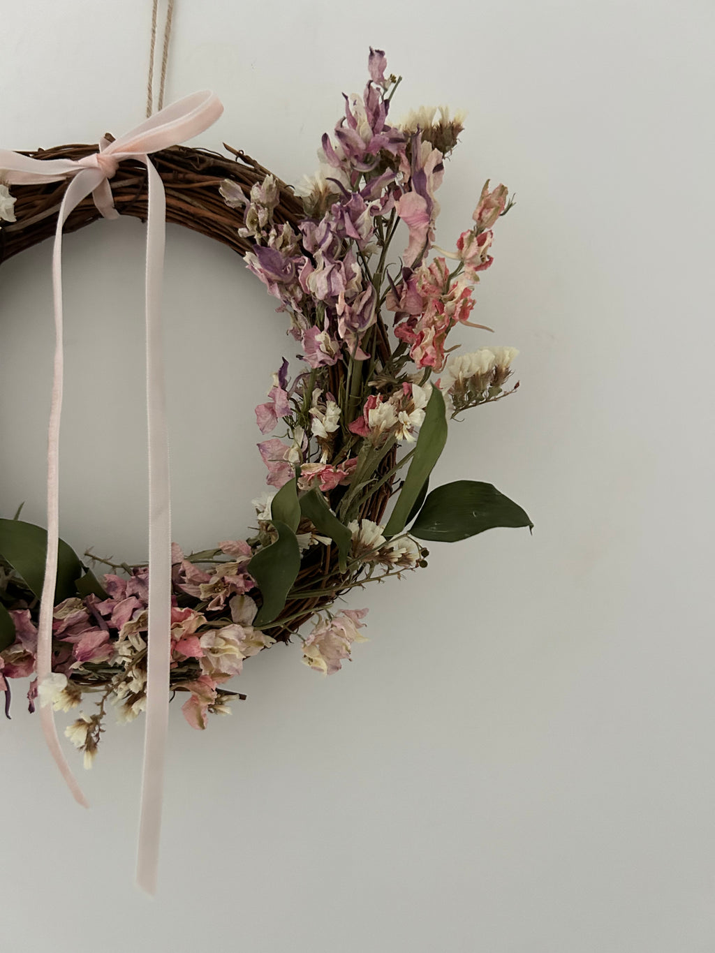 *ONE OFF SAMPLE* ‘Posy’ Wreath with white statice, ruscus and mixed colour delphiniums finished with a light pink ribbon 20cm