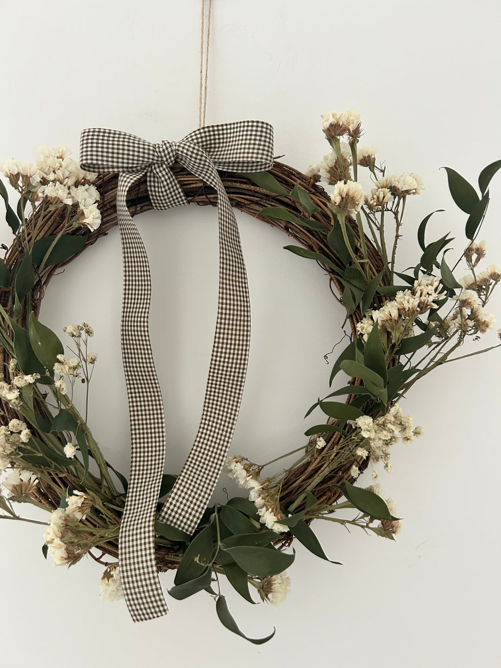 ‘Meadow’ Wreath with White Statice and Ruscus finished with a dark brown gingham bow
