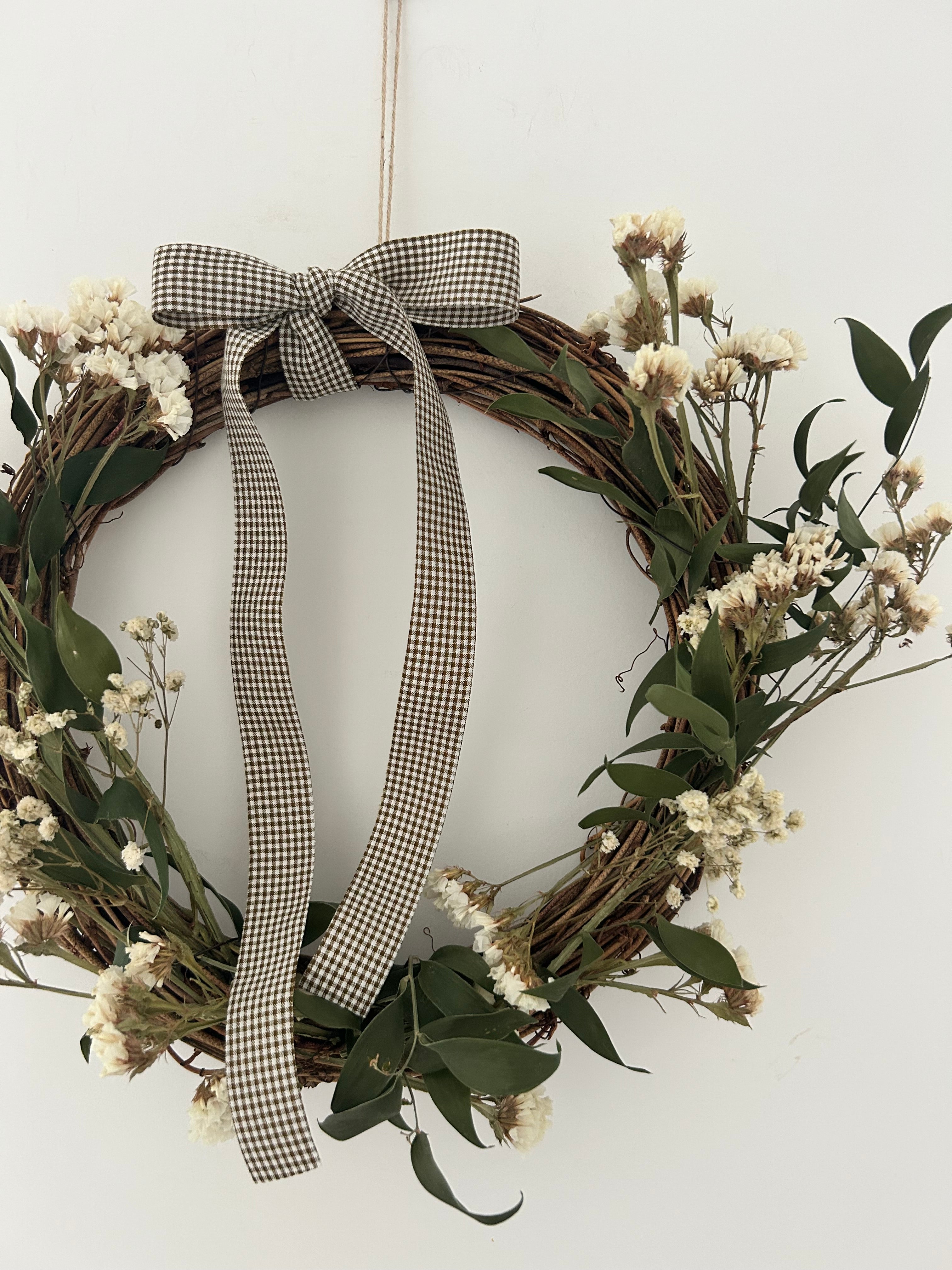 ‘Meadow’ Wreath with White Statice and Ruscus finished with a dark brown gingham bow