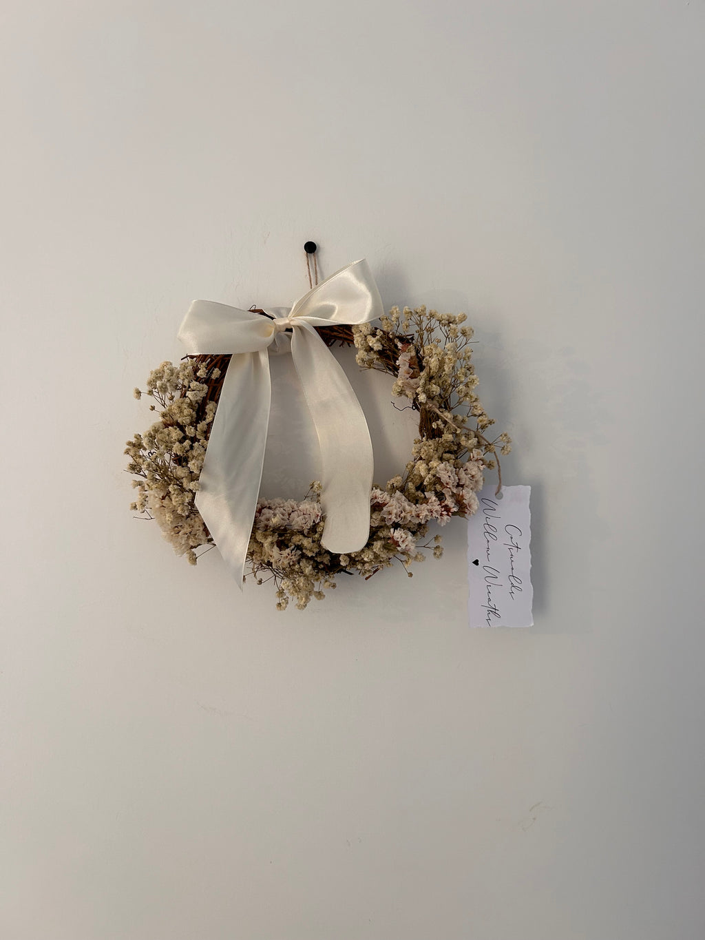 ‘Luchia’ Wreath with white statice, gypsophilas finished with a cream bow