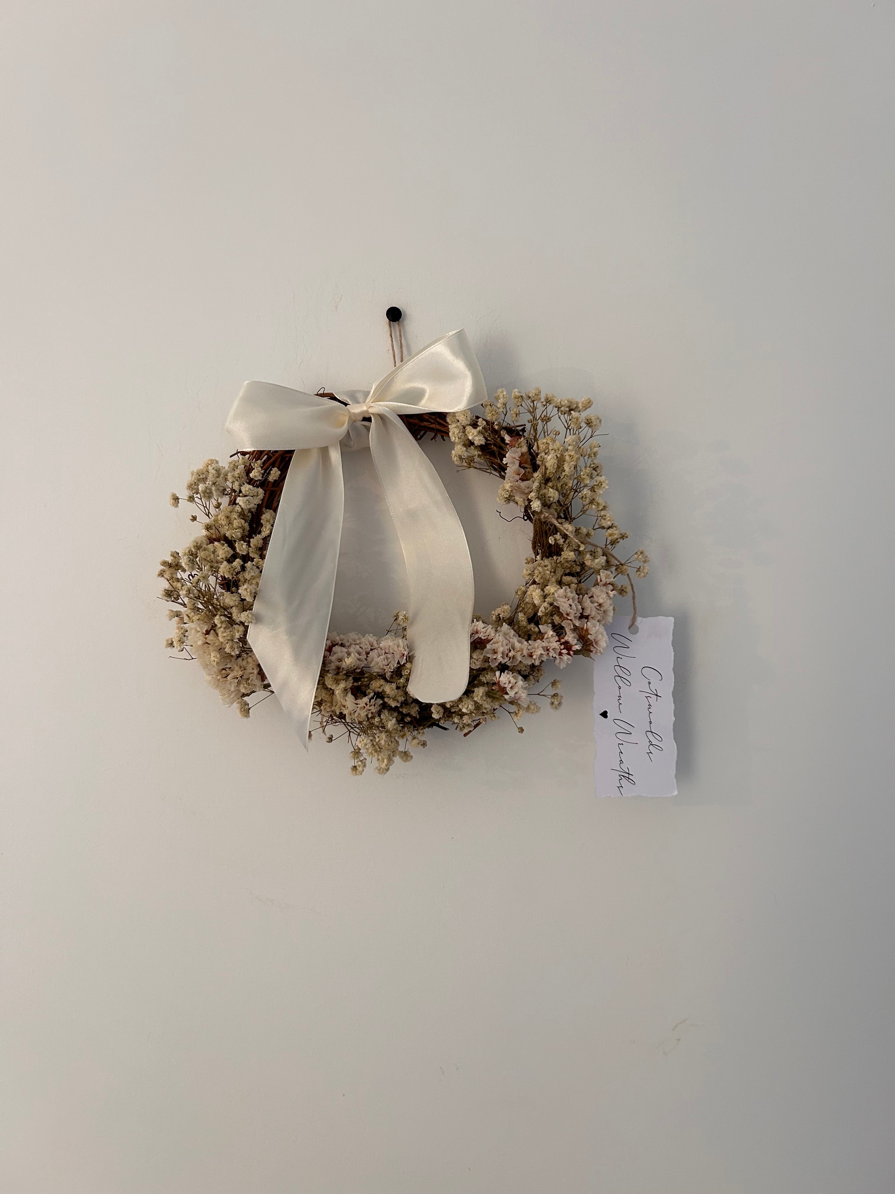 ‘Luchia’ Wreath with white statice, gypsophilas finished with a cream bow