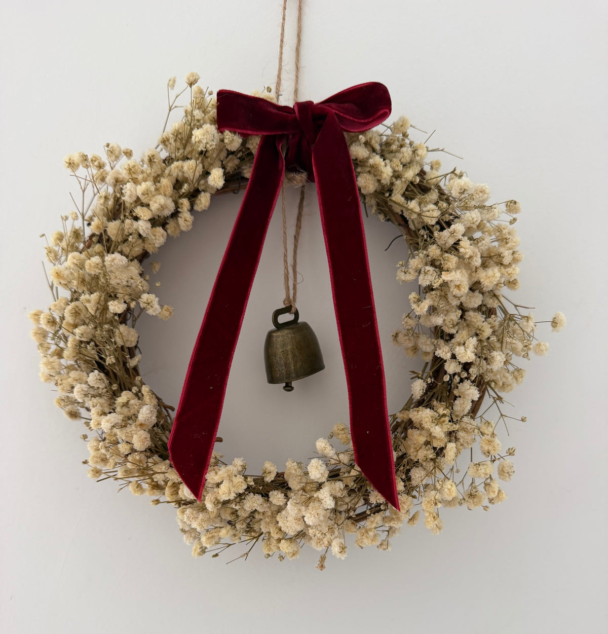 ‘Scarlett’ Christmas Gypsophilas Wreath finished with a red velvet bow & bell