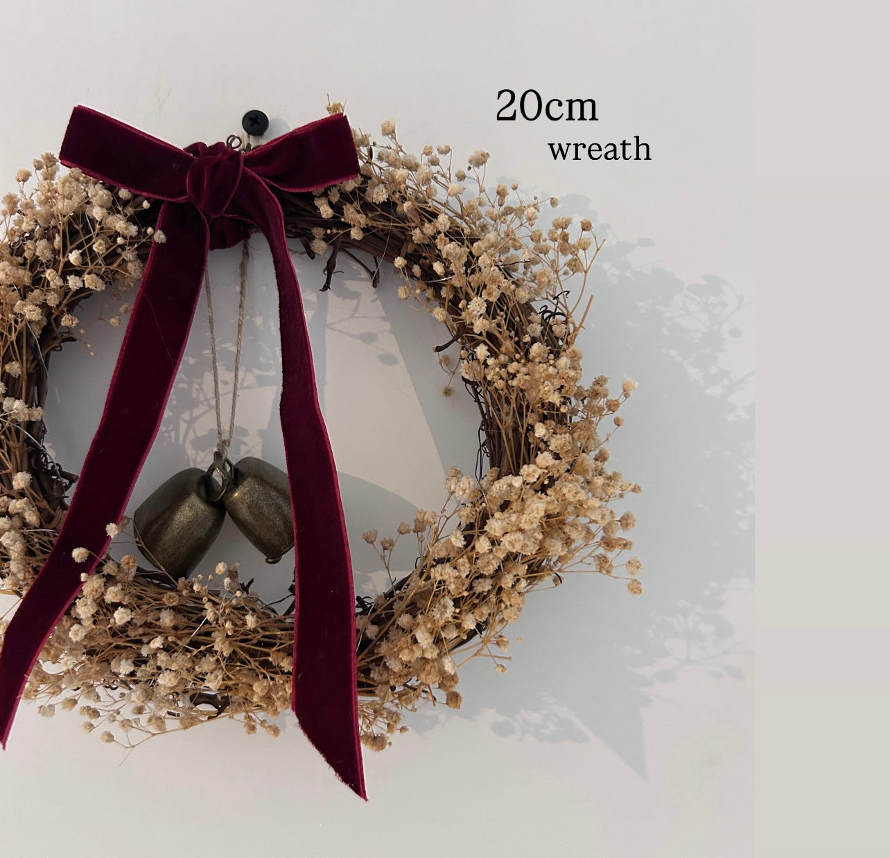 ‘Scarlett’ Gypsophilas Wreath finished with a red velvet bow & bells |