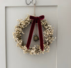 ‘Scarlett’ Christmas Gypsophilas Wreath finished with a red velvet bow & bell
