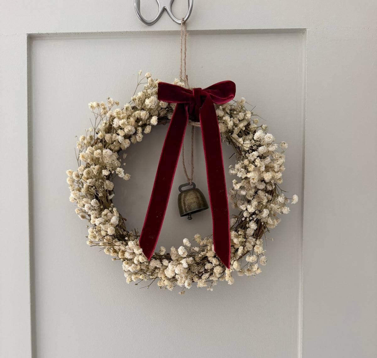 ‘Scarlett’ Christmas Gypsophilas Wreath finished with a red velvet bow & bell
