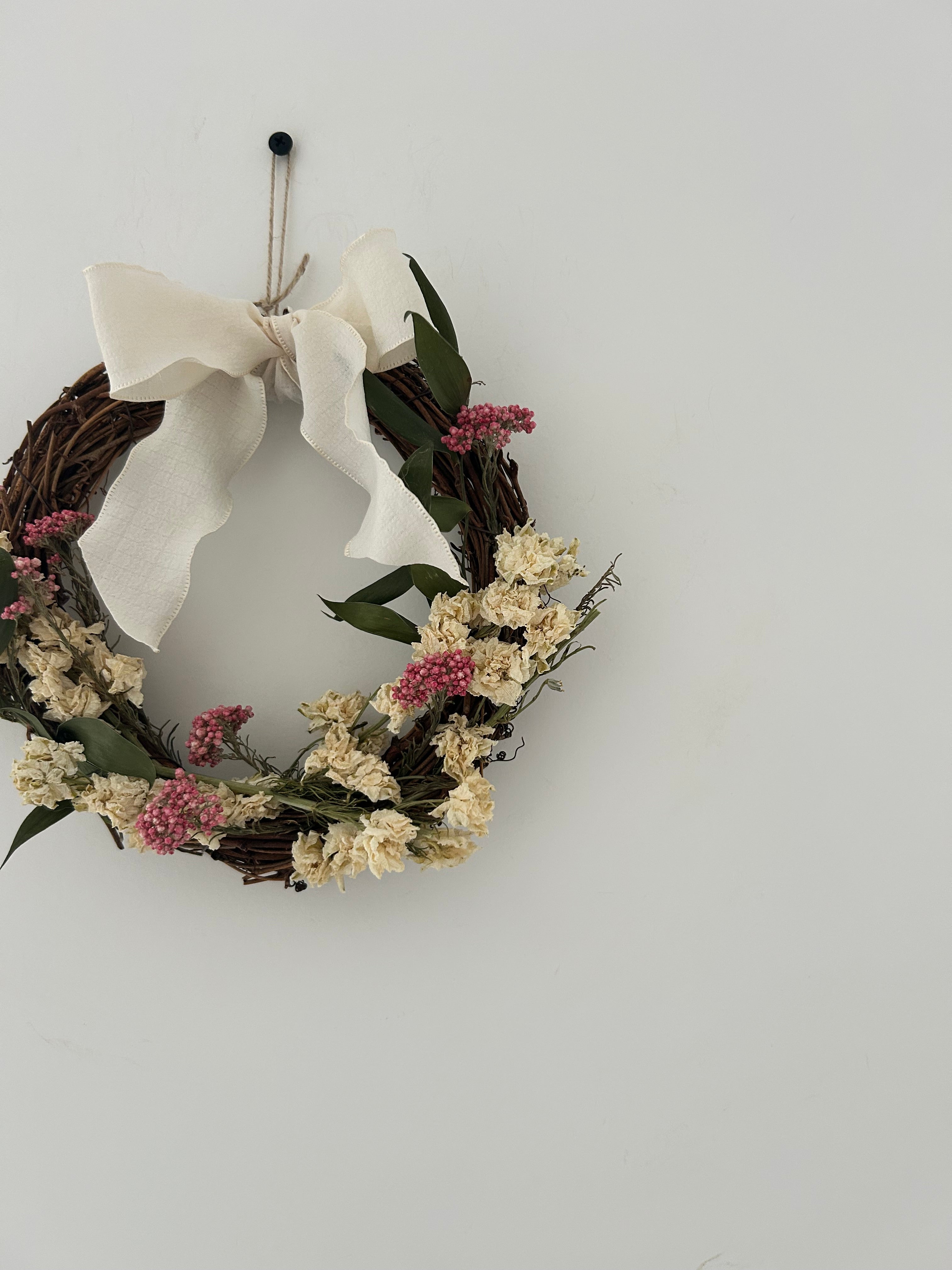 ‘Everlee’ Wreath with White Delphinium’s, Pink Rice Flowers and Ruscus finished with a cream bow 20cm