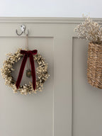 ‘Scarlett’ Christmas Gypsophilas Wreath finished with a red velvet bow & bell