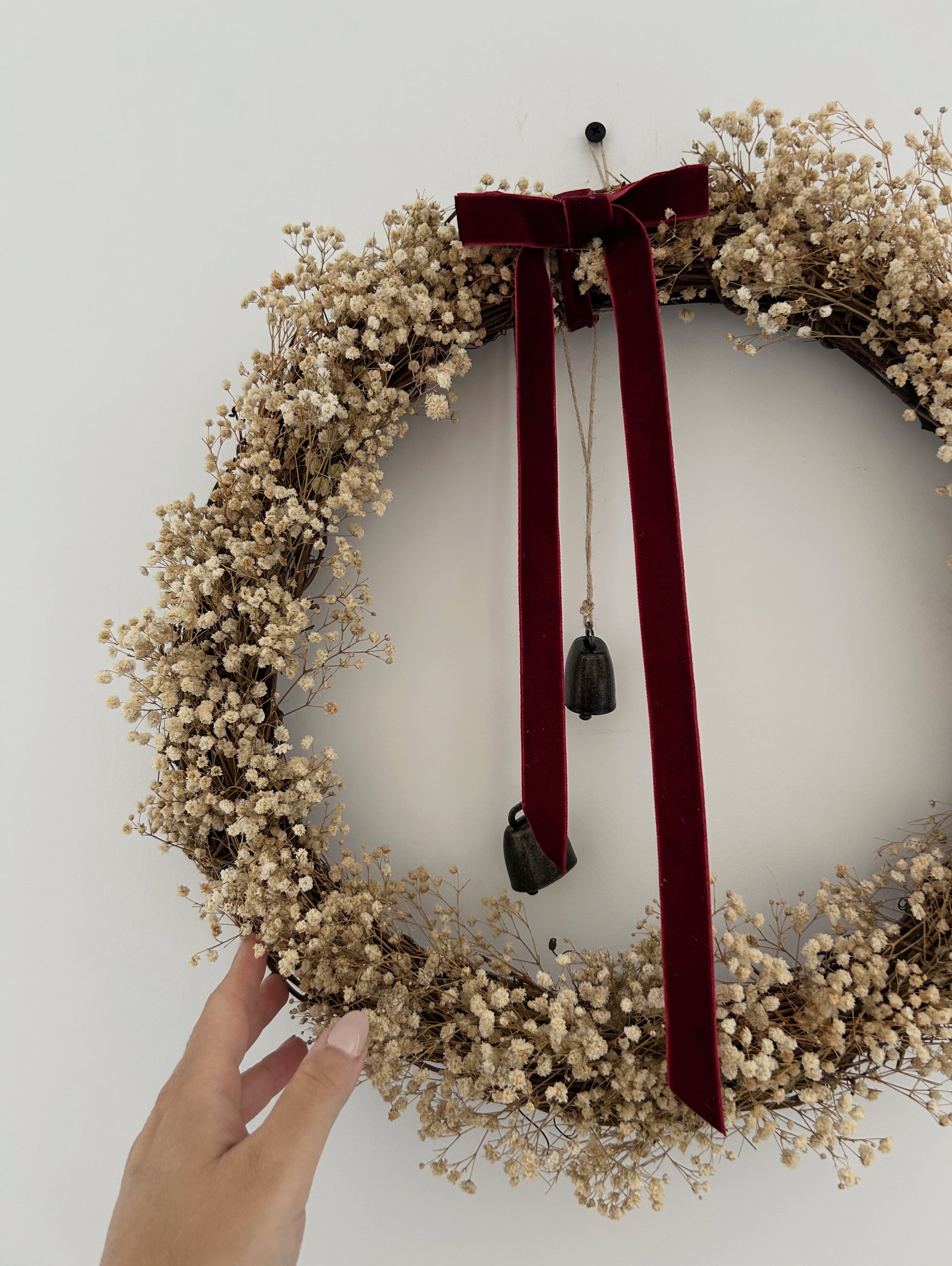 ‘Scarlett’ Gypsophilas Wreath finished with a red velvet bow & bells |
